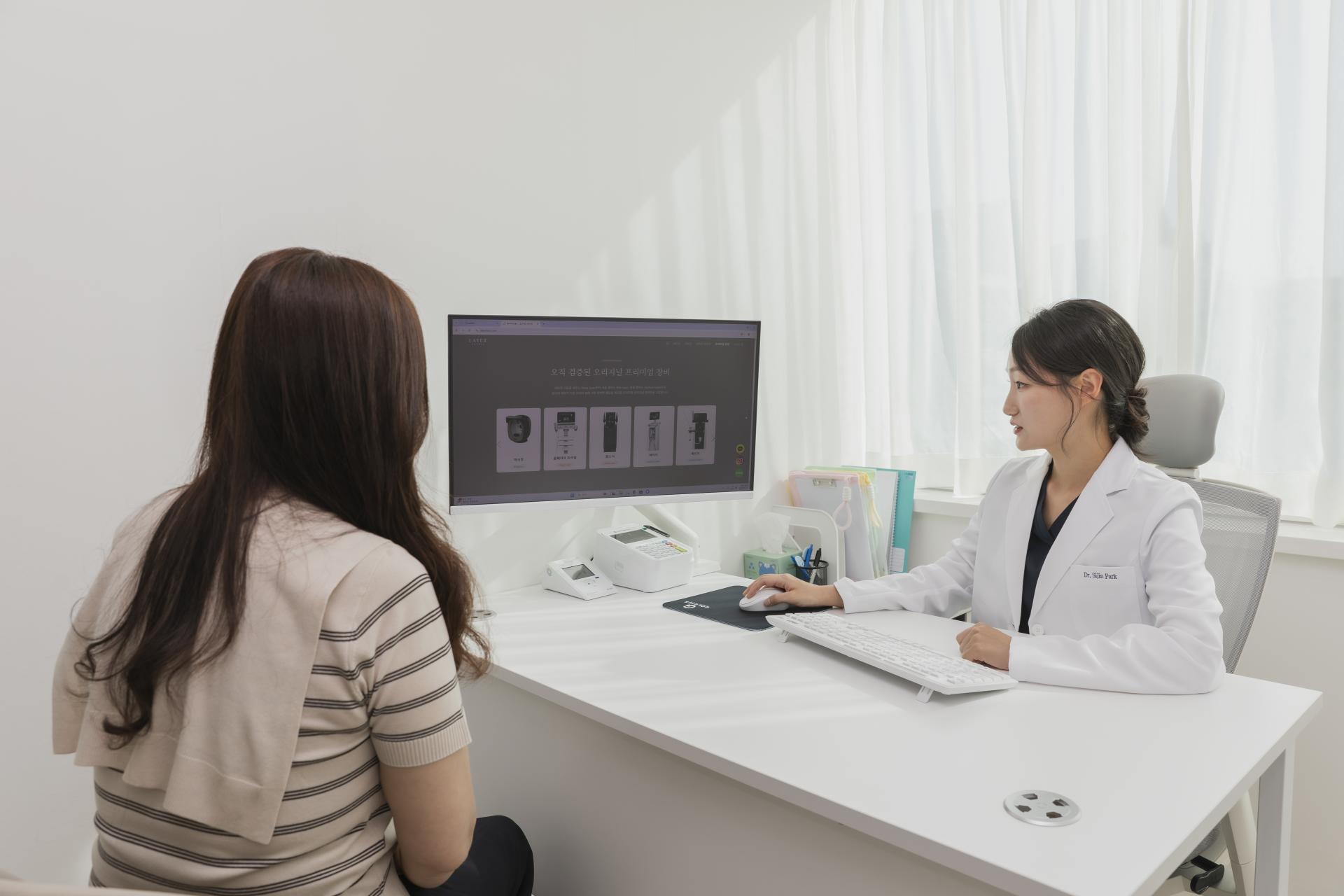 Dr. Sijin Park reviewing a skin analysis with a patient at Layer Clinic